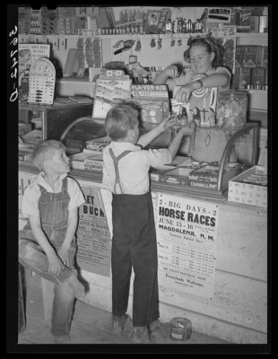 Farm children buying candy at the general store at Pie Town, New Mexico. Black and white photo from 1940.