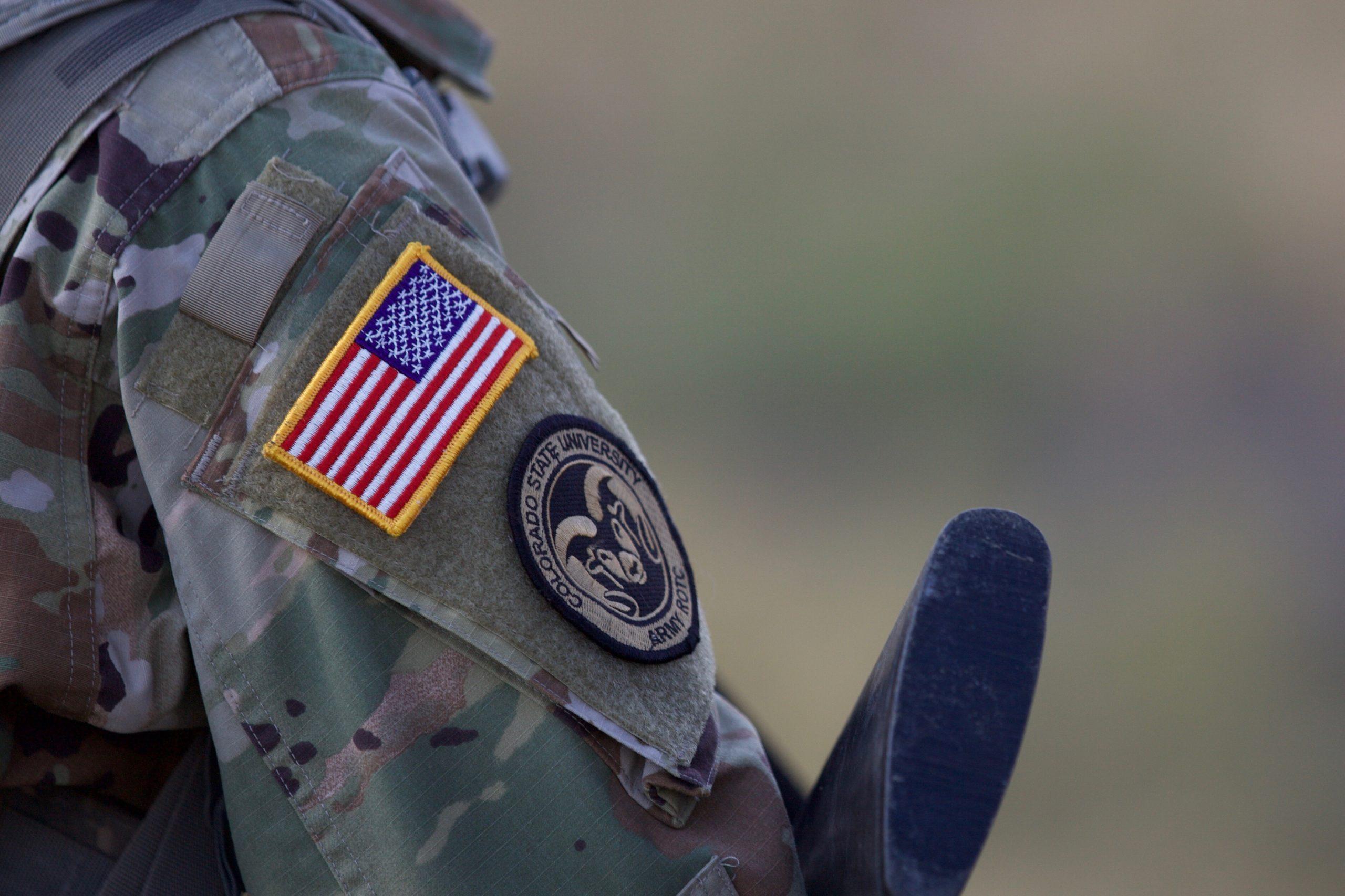 close up photo of american flag and CSU ram patch on military uniform sleeve