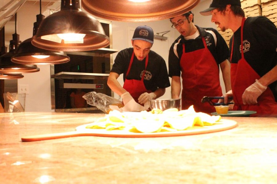 Line+cooks+Zach+Ohmie%2C+Victor+Romero%2C+and+Nate+Hodson+prepare+a+nacho+dish+on+Beau+Jos.