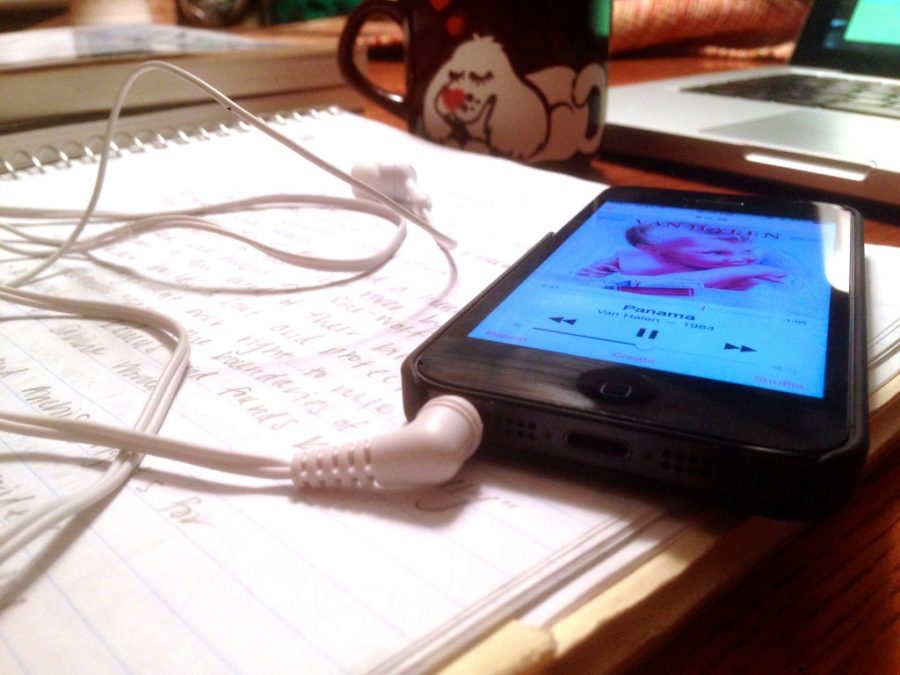 phone with a playlist lying on some notes