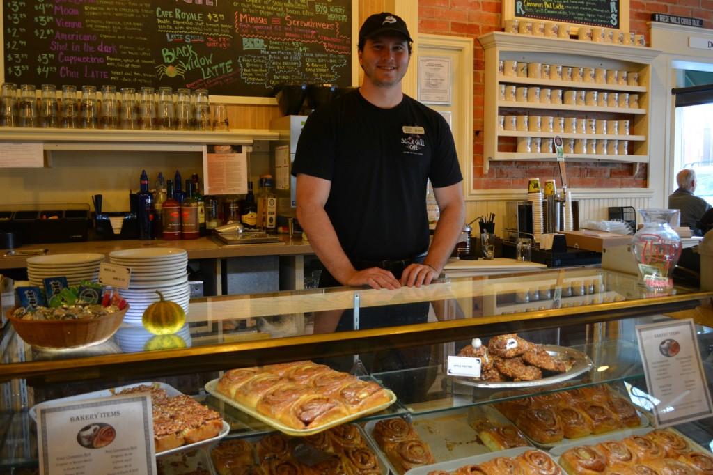 employee at the Silver Grill Café, stands ready to sell the café's famous cinnamon rolls