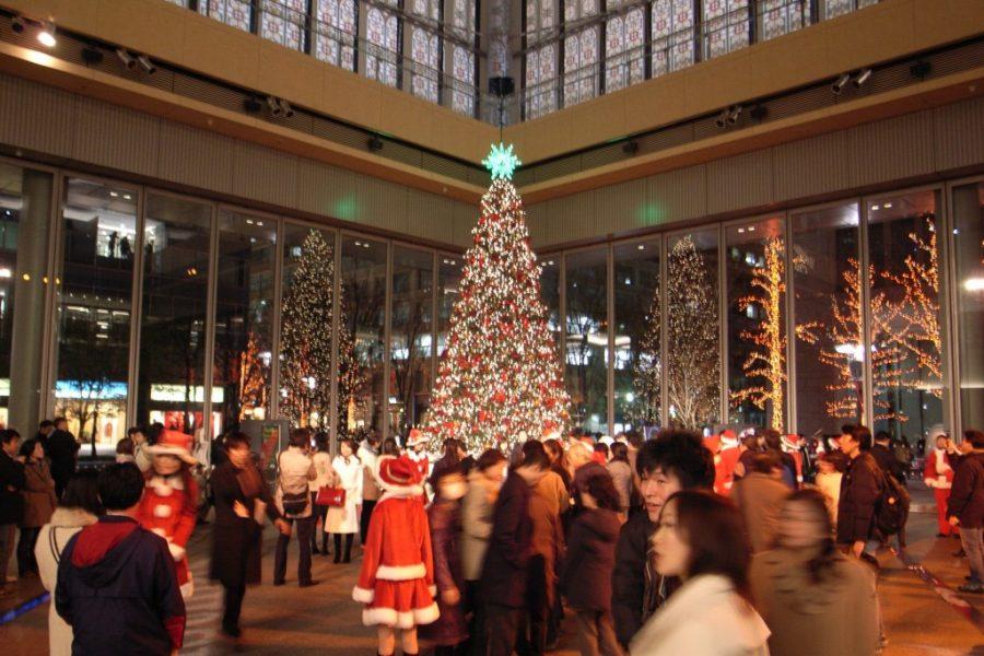 Christmas tree lit in a busy plaza