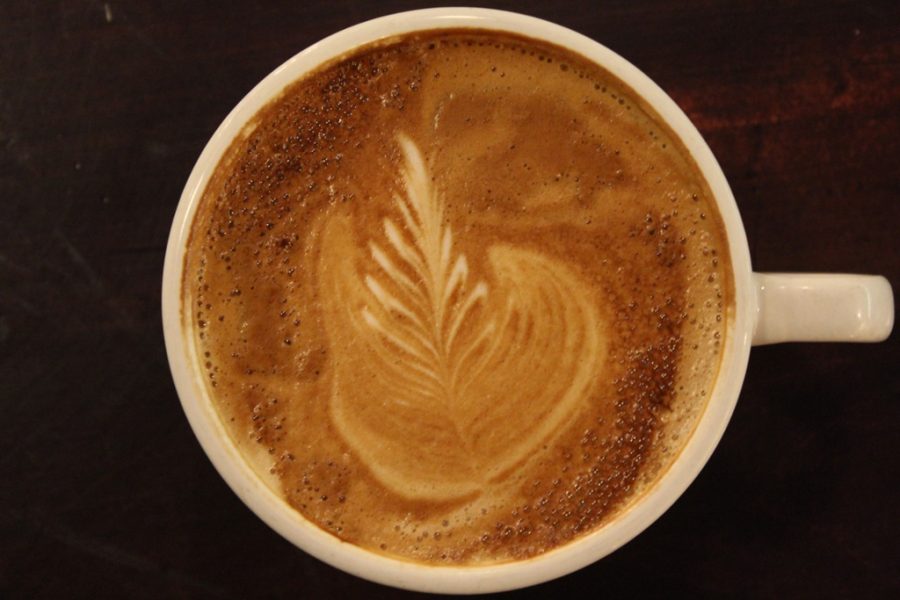 top view of a coffee cup with foam in a leaf pattern