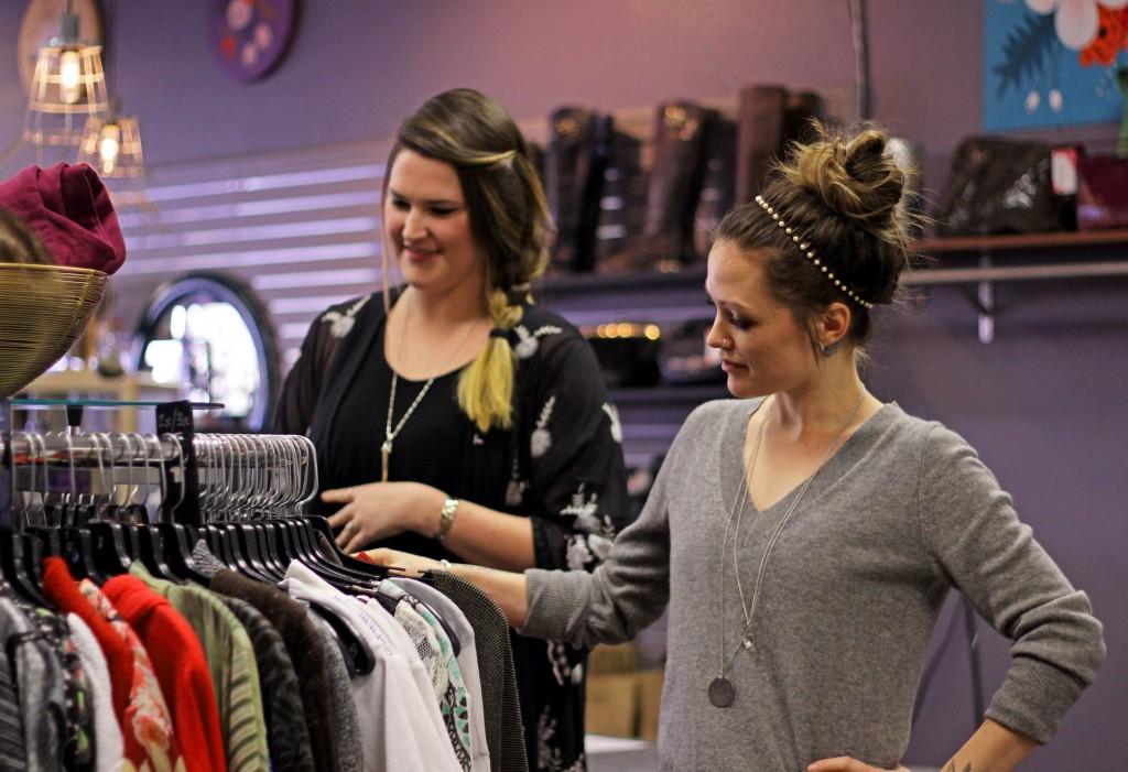 Meghan Morehardt and Danae Carroll organize a clothing display Friday, Jan. 29, 2016. Morehardt and Carroll co-own the consignment boutique. Photo by Jenna Fischer.