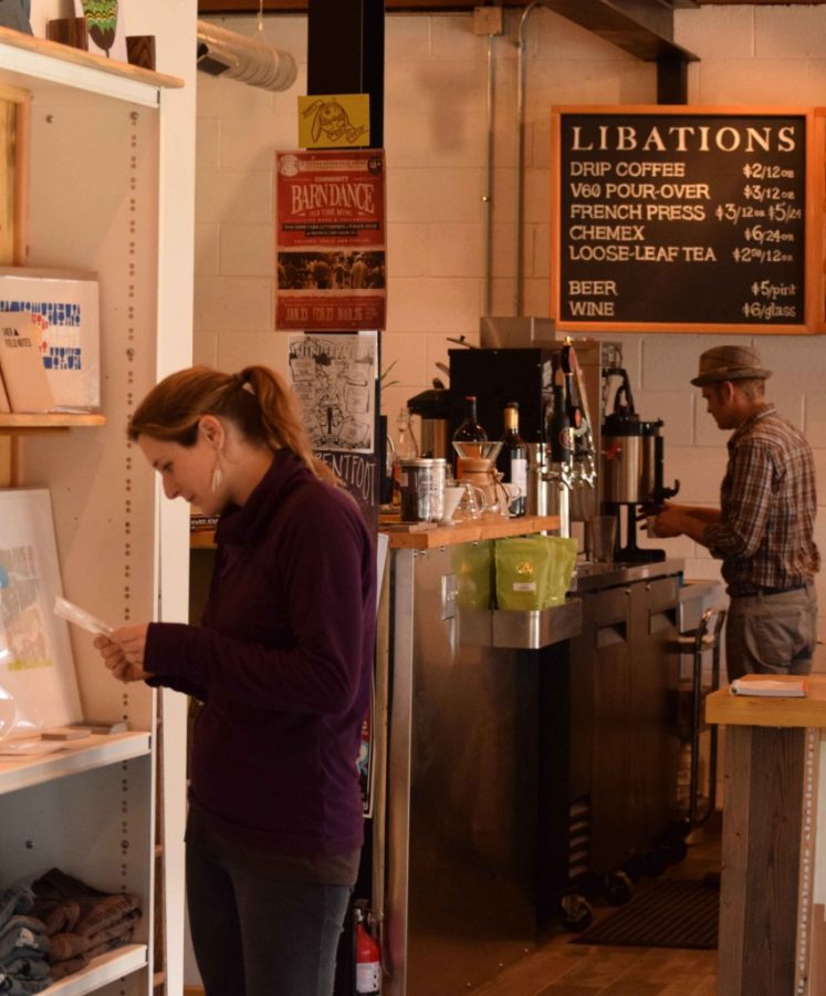 Todd Simmons (right) serves up a coffee while a customer (left) browses the locally made crafts, art, and books sold in the Letterpress and Publick House.