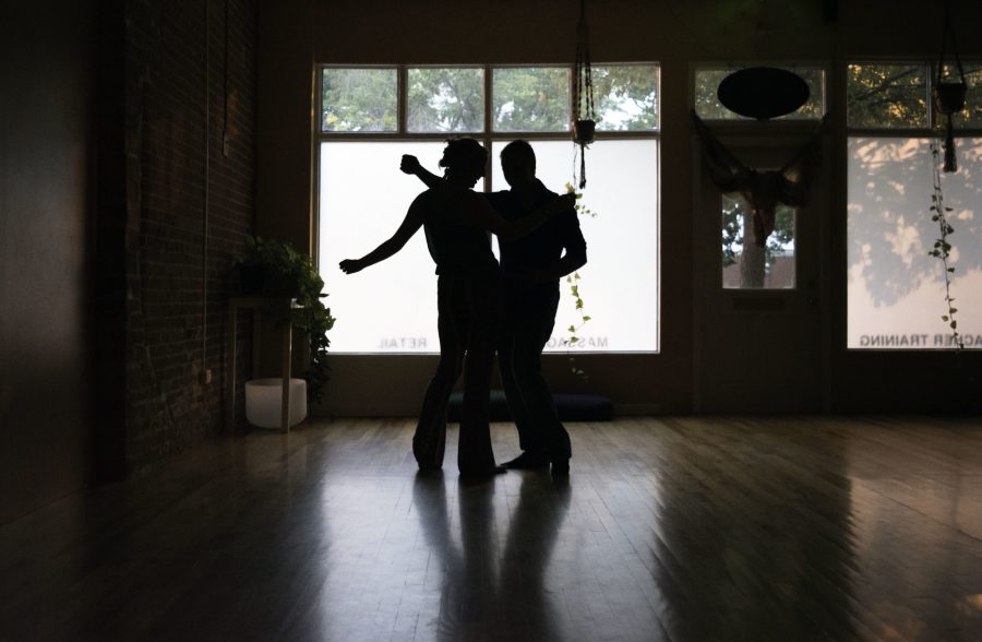 Silhouetted in front of the windows of Old Town Yoga’s front studio, this couple groove it out to some traditional blues tunes. Photo credit: Brooke Buchan