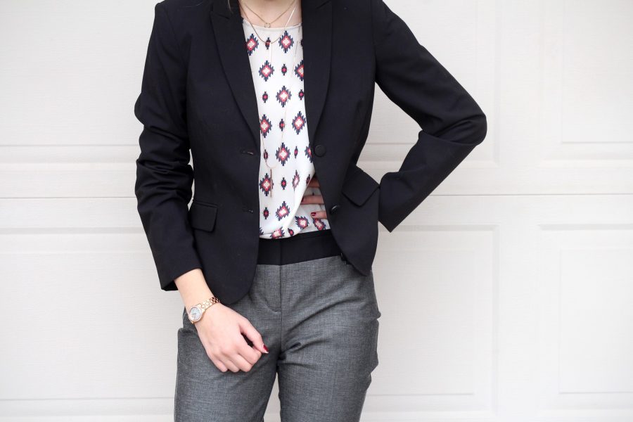 woman wearing a blazer, diamond patterned shirt, and slacks