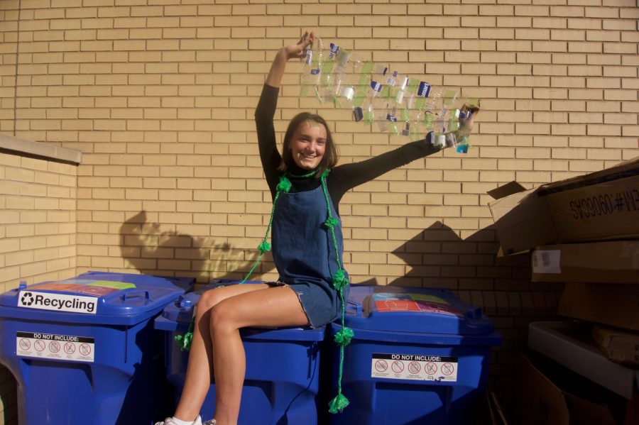 Van Hatten proudly showing off a portion of her costume perched atop the bins where she found her materials.