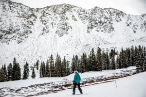 skier in front of snowy colorado mountain