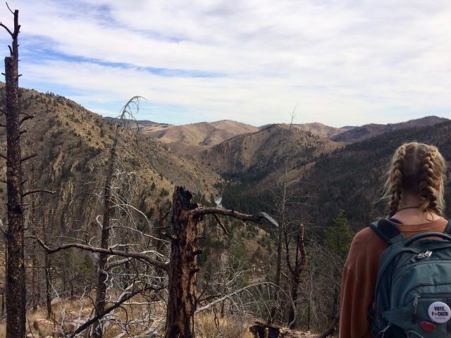 Alea Schmidt, Colorado State University sophomore majoring in interior design, dazed in the Poudre Canyon trails outside of Fort Collins. Photo credit: Jacob Stewart