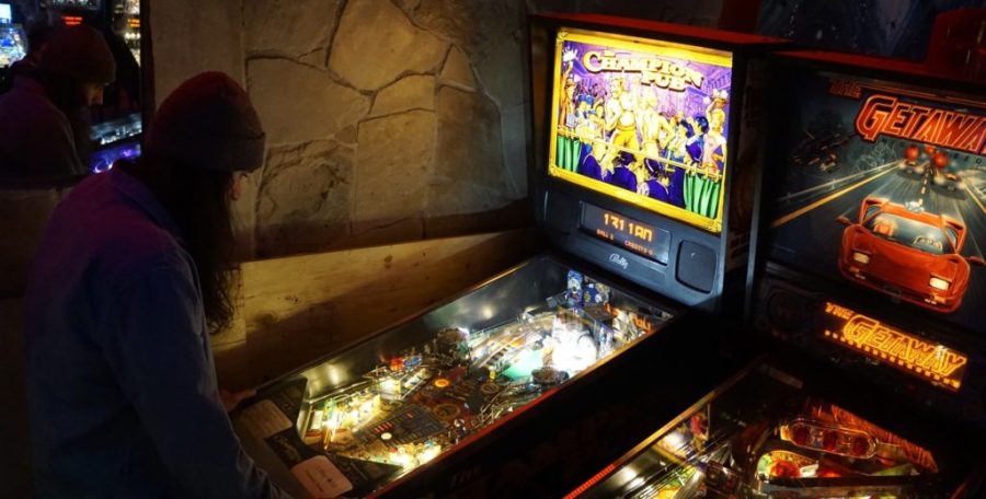 A+patron+playing+one+of+the+many+pinball+games+offered+at+the+bar-cade.+There+is+both+vintage+and+brand+new+pinball+games+to+be+played%2C+and+many+of+them+for+under+a+dollar.+Photo+credit%3A+Erik+Fideor