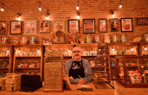 Tony Vallejos, owner of Fort Collins Candy Shop Emporium, stands behind the counter at his shop. (Photo by Mackenzie Pinn | College Avenue Magazine)
