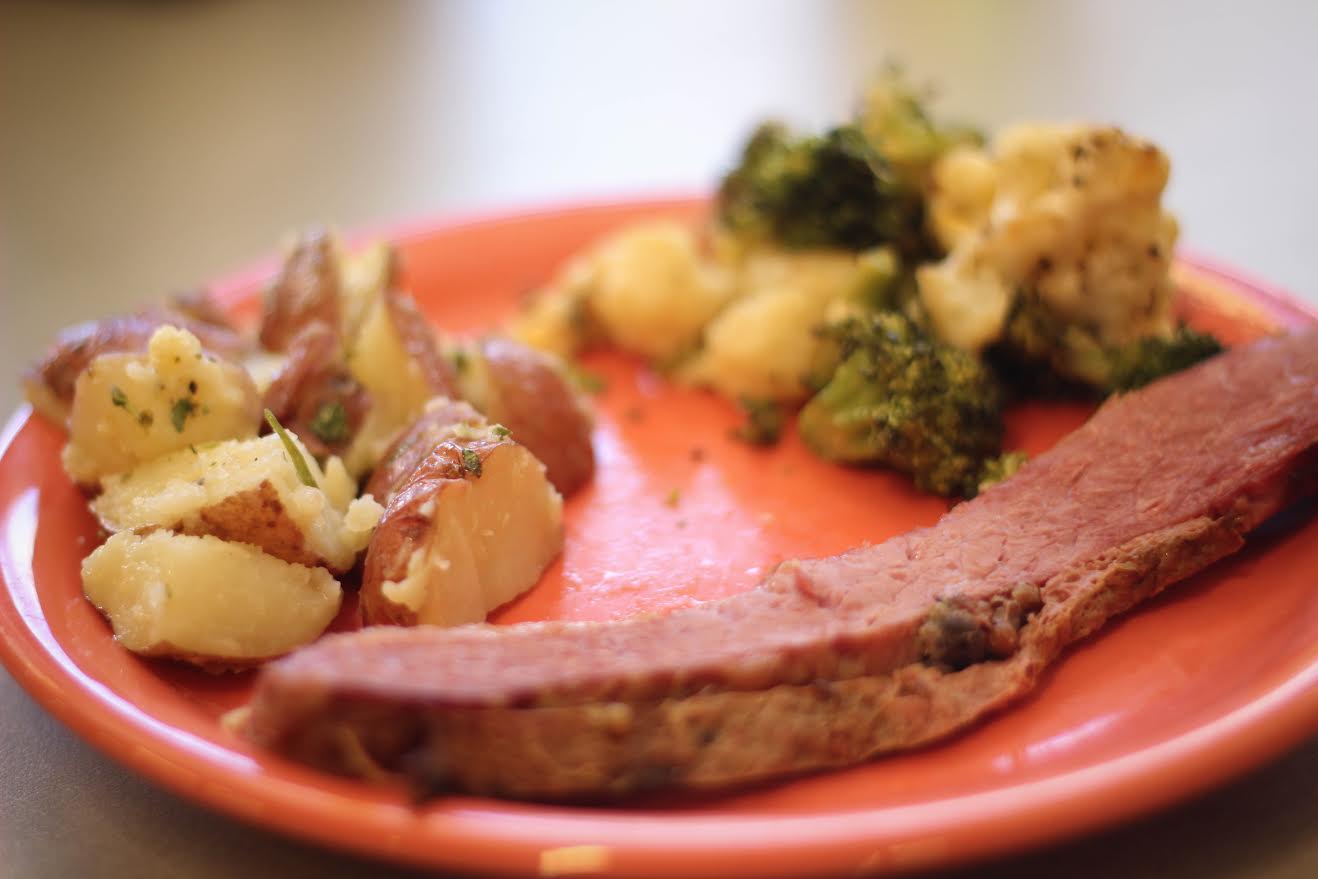 A cut of corned beef is one example of an entree that adheres to the paleo diet. Broccoli, cauliflower and roasted potatoes are great options for sides. Individuals on a paleo diet may only consume food products that a caveman would have eaten. Photo by Jenna Fischer.