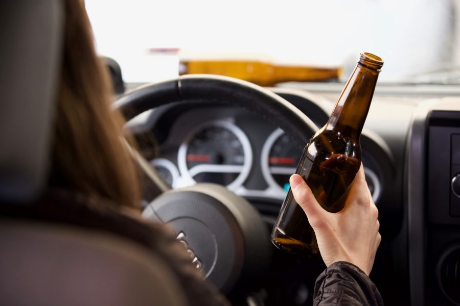 Person+in+drivers+seat+of+car+holding+a+bottle+of+alcohol