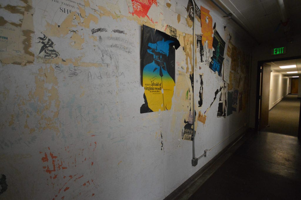 torn posters on a wall