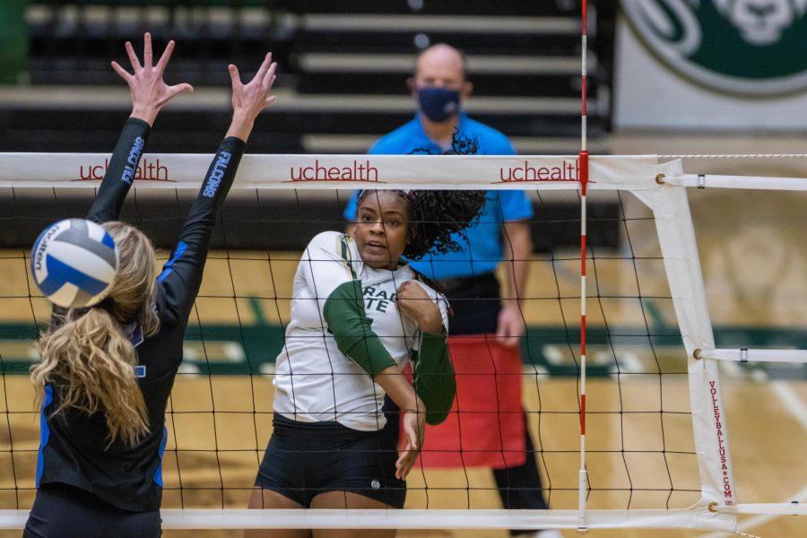 CSU volleyball player jumps in midair to hit the ball