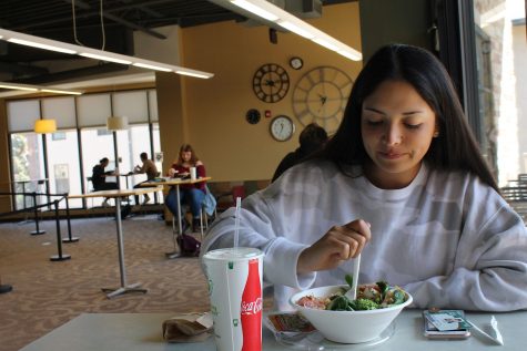 Sofia Torres eats her lunch in the dining area at Rams Horn. Students can eat in the dining halls, but seating is limited and not always available.(Photo by Noel Black)