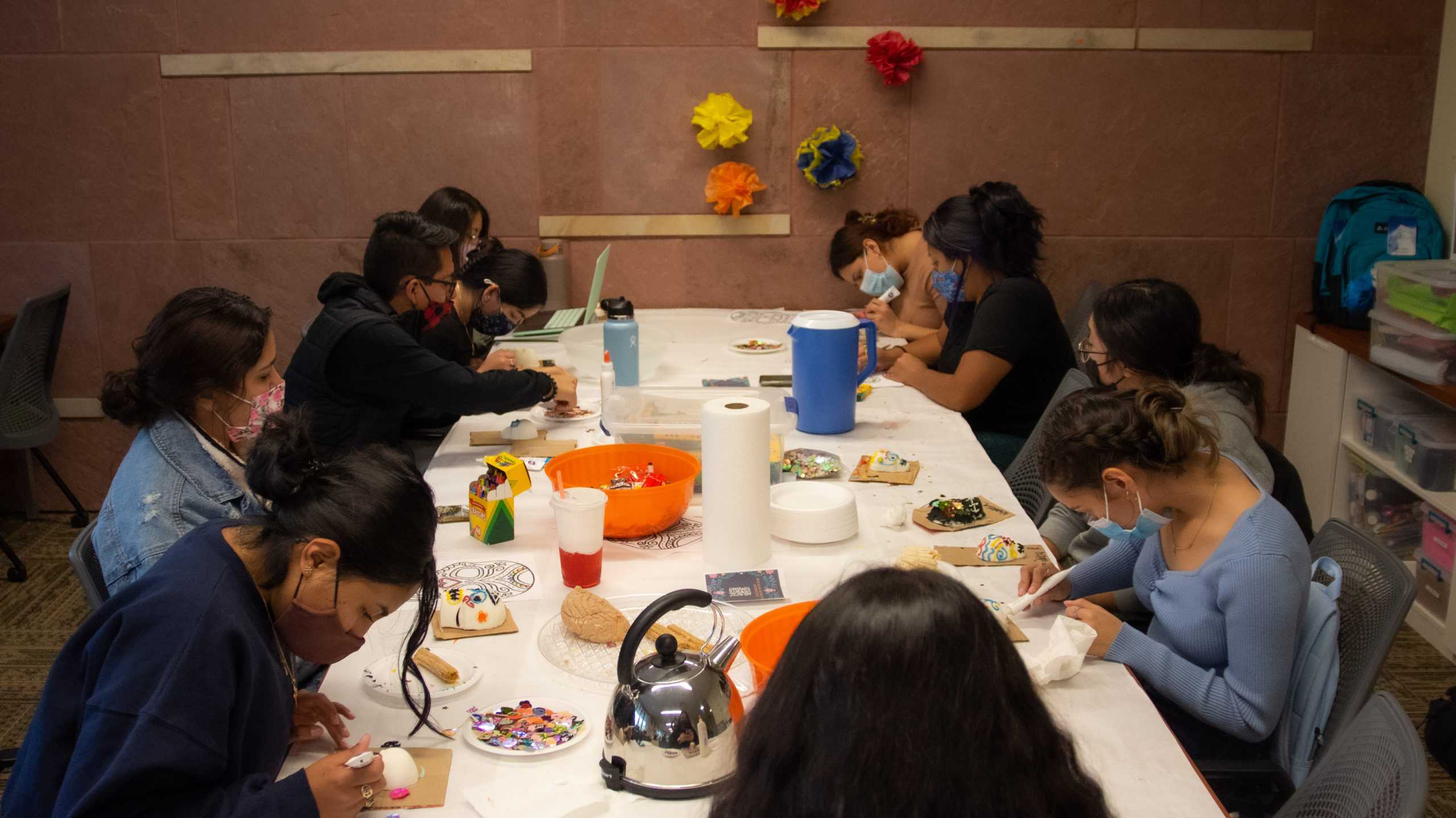 Students at El Centro decorates sugar skulls for Day of the Dead