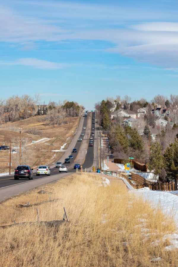 Cars drive on S Shields St between the Cathy Fromme Prairie natural area and the Fossil Creek neighborhood in Fort Collins on Wednesday, Feb. 9, 2022. (Anna von Pechmann | College Avenue Magazine)