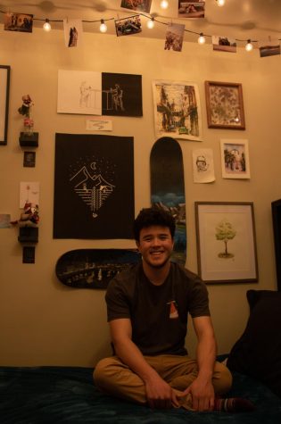 Graphic design senior, Micah Hwang, sits in front of his bedroom wall of artwork April 3. “I definitely chose to do graphic design, but it did help that growing up my siblings and I were artistic because of our dad, since he was a painter when he was younger, said Hwang. (Anna Tomka | College Avenue Magazine)