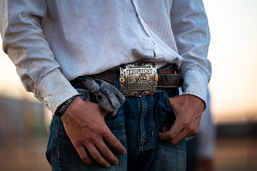 Member of the Colorado State University rodeo team sports a Boys Ranch championship buckle during practice in Eaton Aug. 29.
