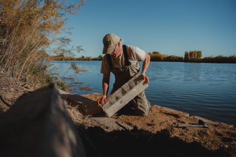 Mark Nagle places rocks at River's Edge Natural Area in Loveland, CO.