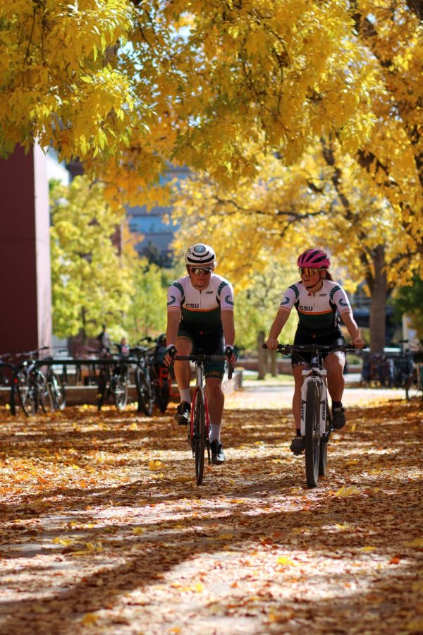 Andreas Broxson and Isabel Naschold bike through the CSU Plaza.