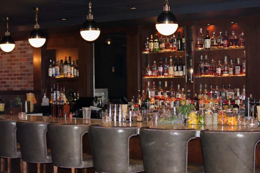 The Ace Gilletts bar shelves are filled with different brands, flavors and types of spirits.
