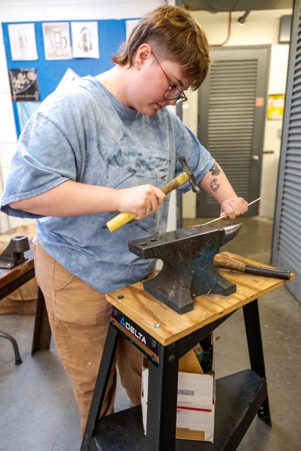 Syd Hanna hammers a piece of copper for use in an art piece at the Colorado State University Visual Arts Building March 26.
