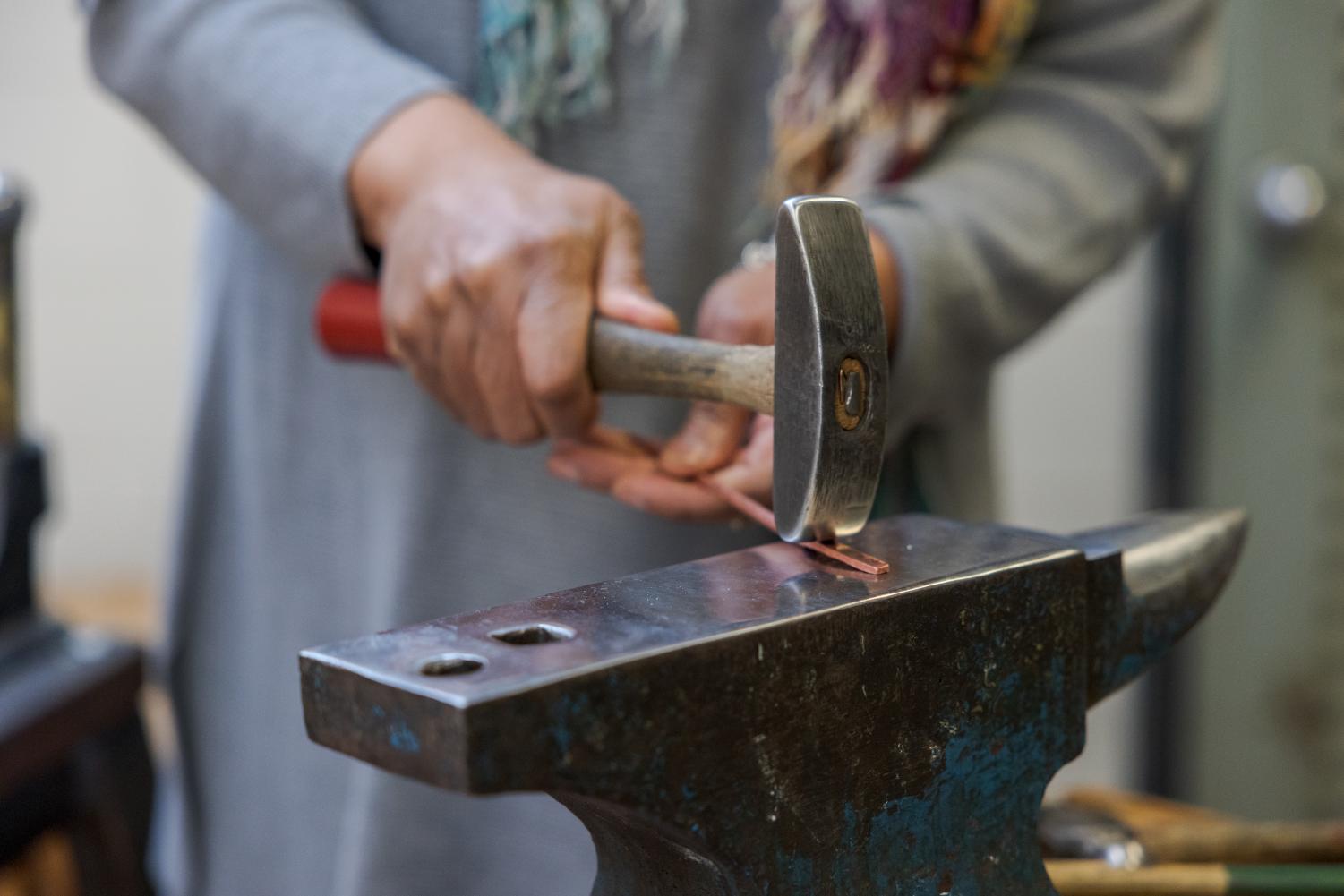 Joclyn Goss shapes a copper rod into a spoon at the Colorado State University Visual Arts Building March 30.