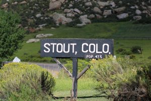 A sign reading "Stout, Colo. pop. 47 1/2" stands just south of where the original town of Stout once stood Sep. 7.