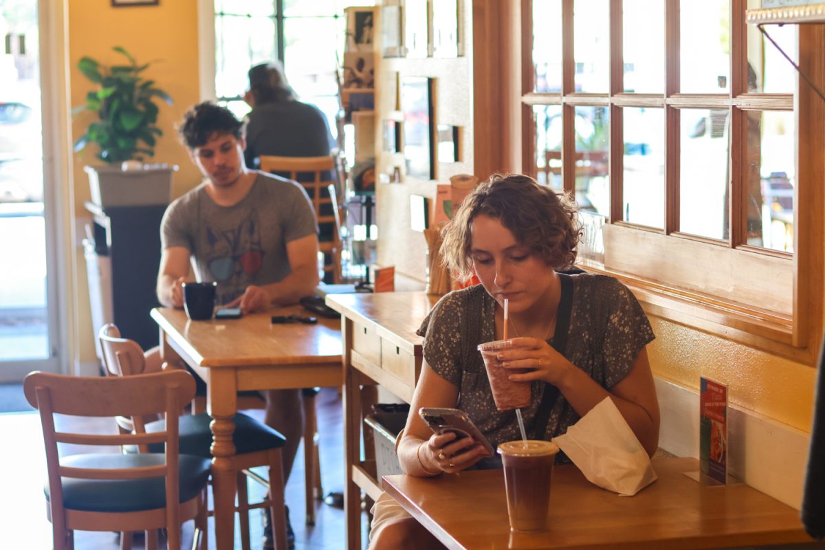 Annie Hessler, waits for her friend as she sits at one of Momo Lolo Café’s tables, Sep 8. “Momo Lolo has a very relaxing atmosphere to just grab coffee with a friend but it also  just makes studying easier for me,” explained Annie.