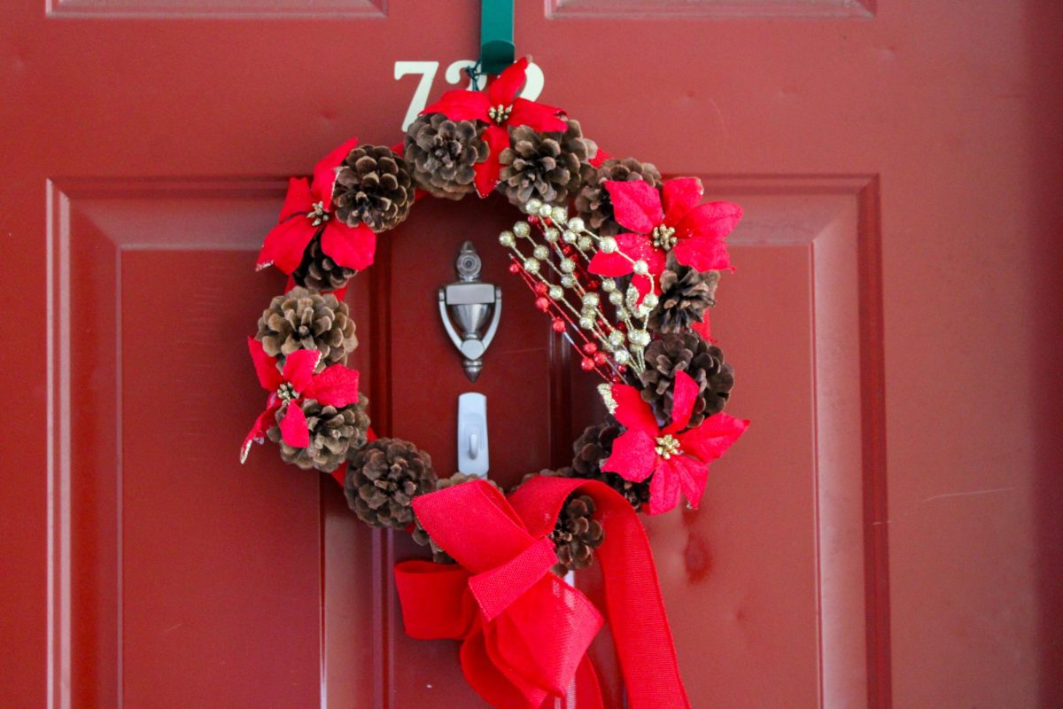 A Christmas wreath hangs on a red door Dec. 21.