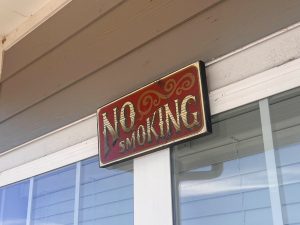 A "No Smoking sign hangs above Rowan Kimble's porch April 4.