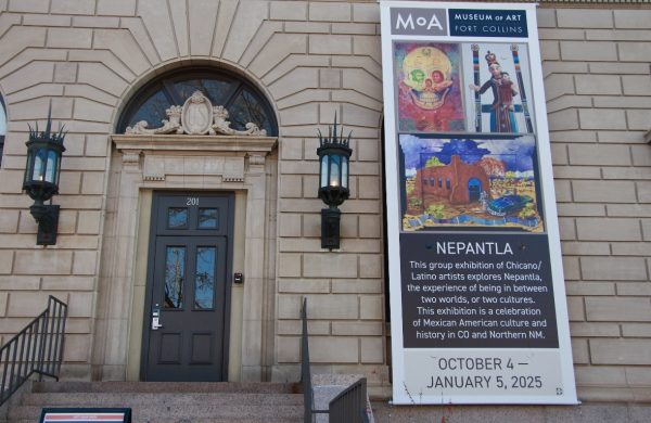 A banner advertising the Nepantla exhibit at the Fort Collins Museum of Art is displayed in Old Town Fort Collins.