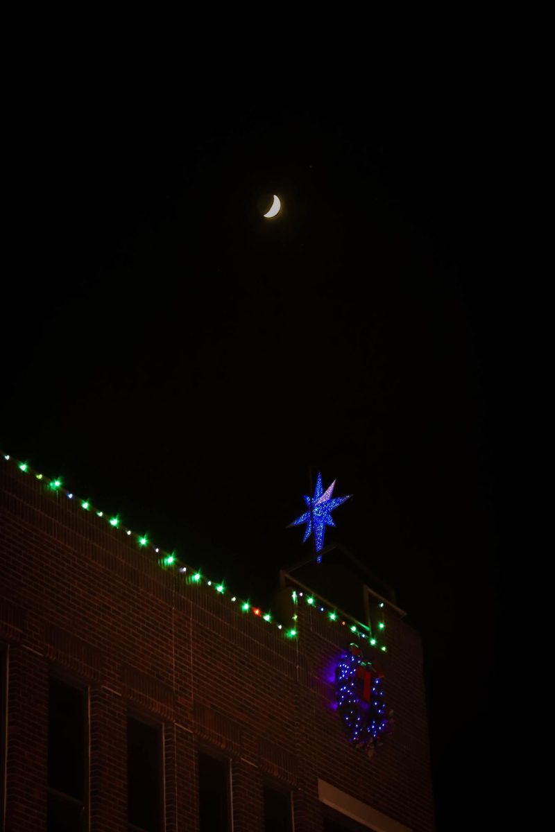 The moon above Christmas lights in Old Town, Fort Collins Dec. 6, 2024.
