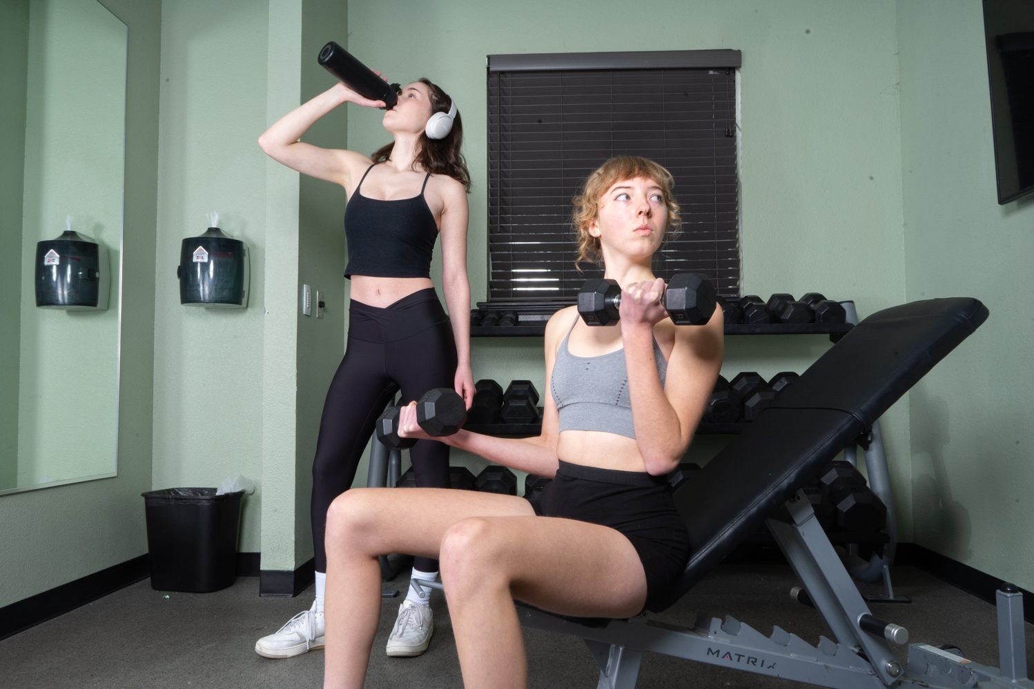 Ellie Keating and Ava Hulsebus model athletic wear in Campus Crossing at Ram's Pointe apartment gym Feb. 1.
