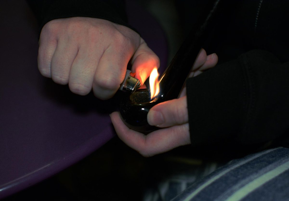 Ashley Baron brings the lighter to the pipe and sparks a fire inside March 20. 