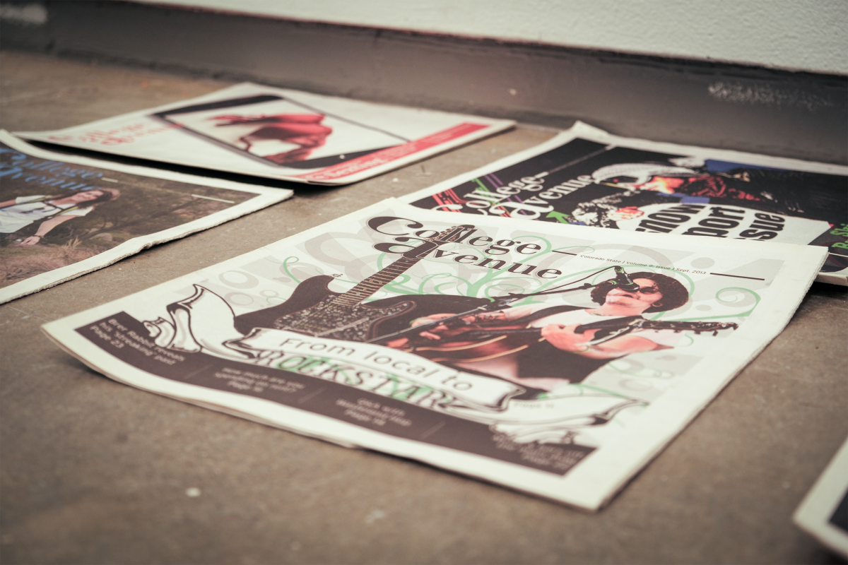 Old newspapers, titled "College Ave," laid out on the floor at an angle. CSU Art and Art History, Fort Collins, Colorado, 10/19/25.