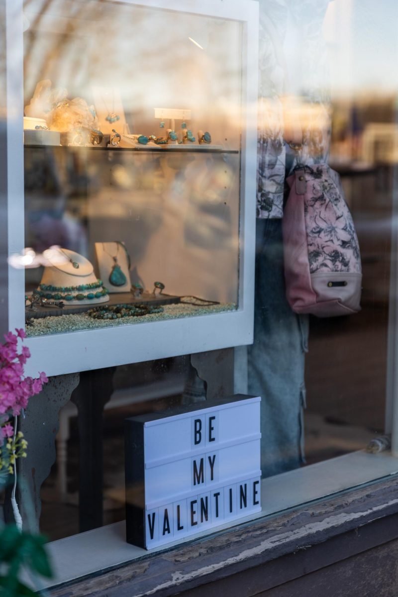 Three Blessed Gems adding a holiday message to their window display, Fort Collins, Colo, Feb. 5.